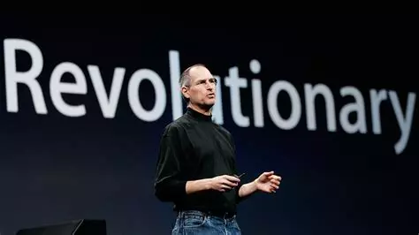 An Apple launch by Steeve Jobs with the word 'revolutionary' projected wide behind him